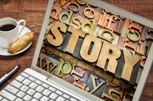 Laptop with Story in block letters on screen